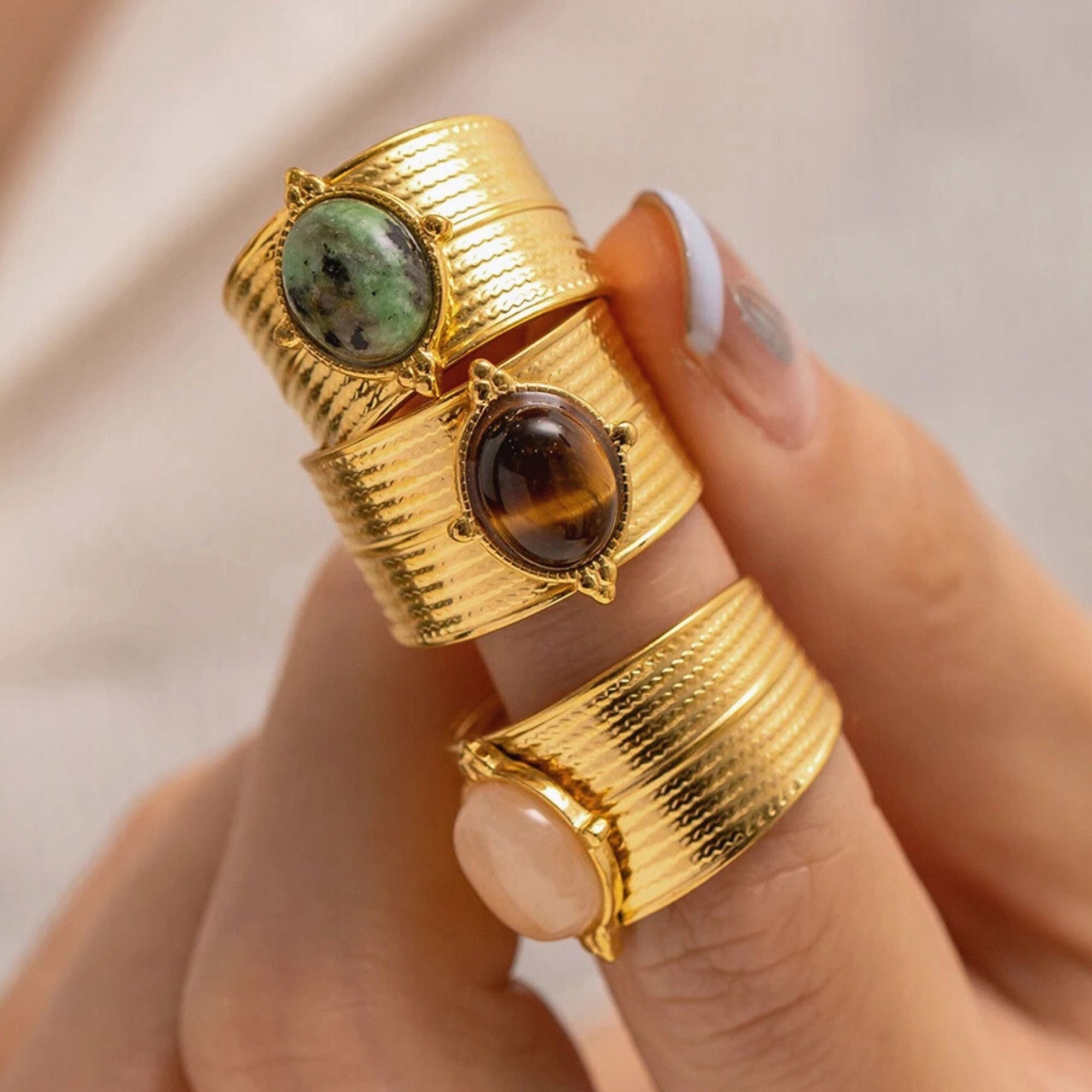 Statement adjustable gold rings with natural gemstones stacked on fingers
