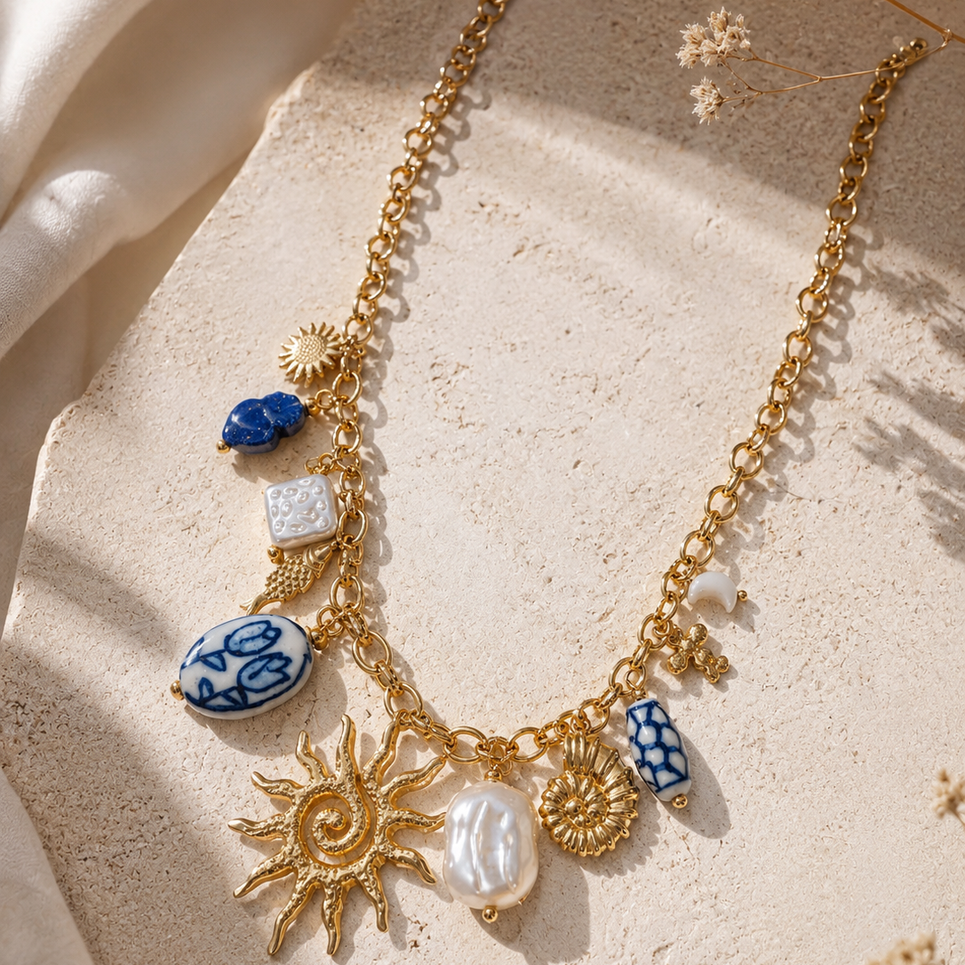 Sun charm necklace with blue ceramic charms flatlay