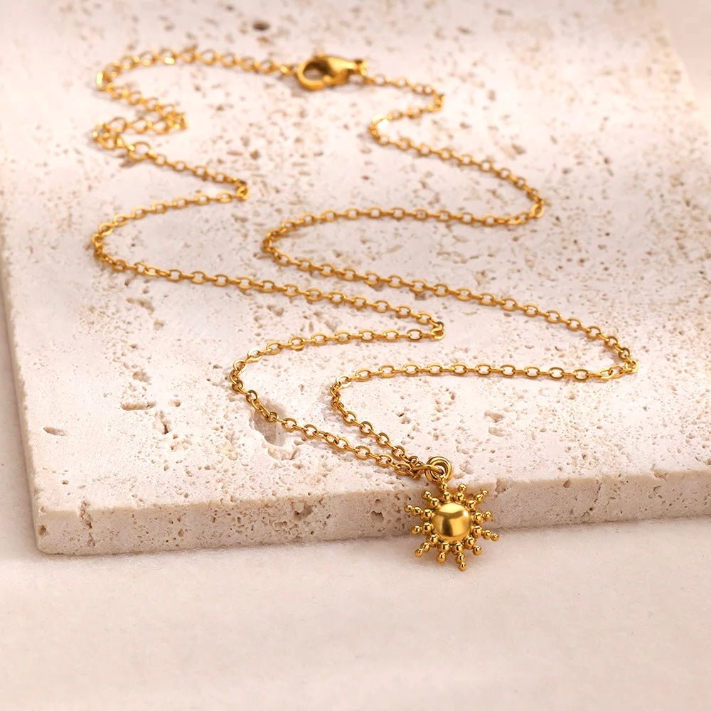 Minimalist sunburst pendant on delicate chain in gold finish
