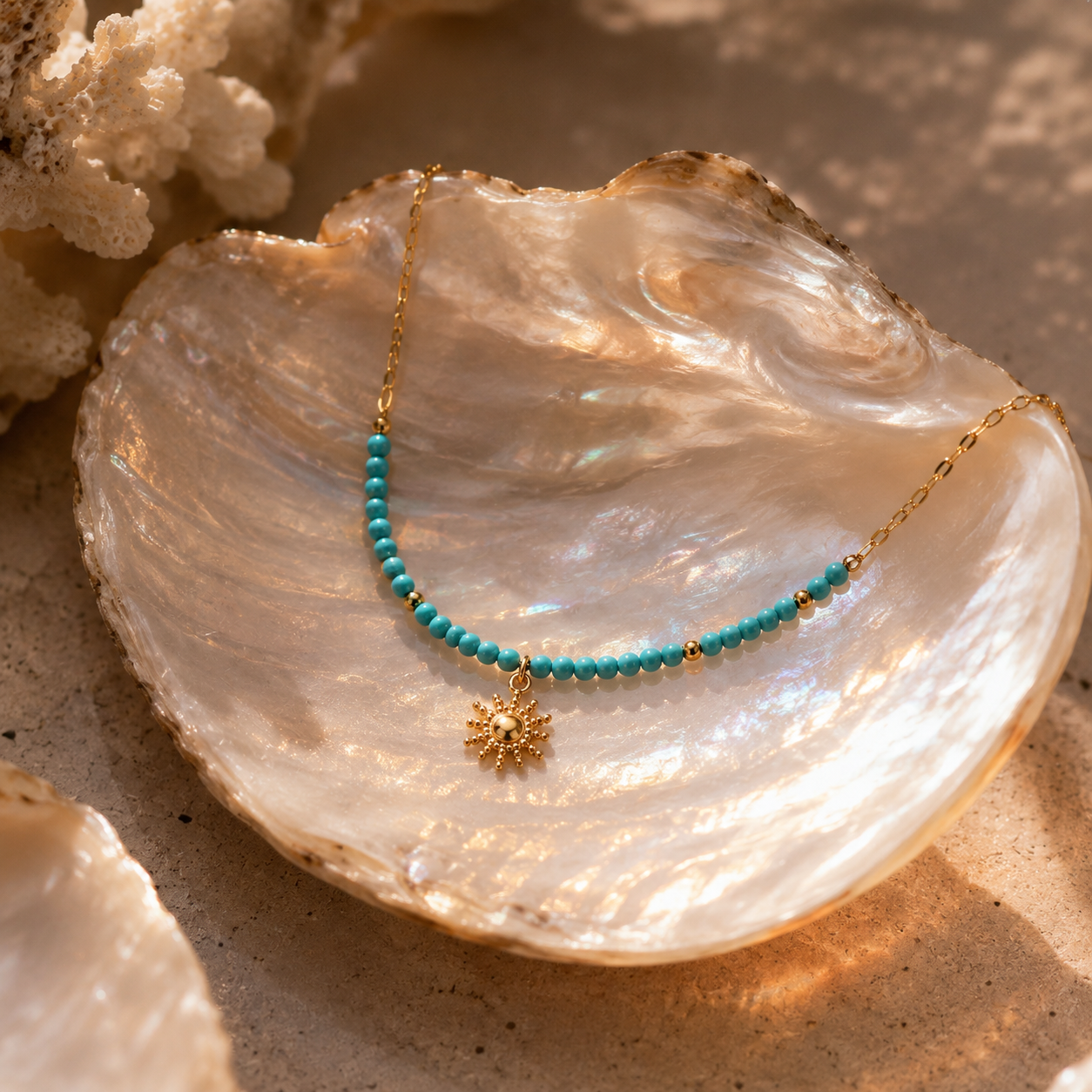 Turquoise Sun Necklace displayed on an iridescent shell in warm sunlight