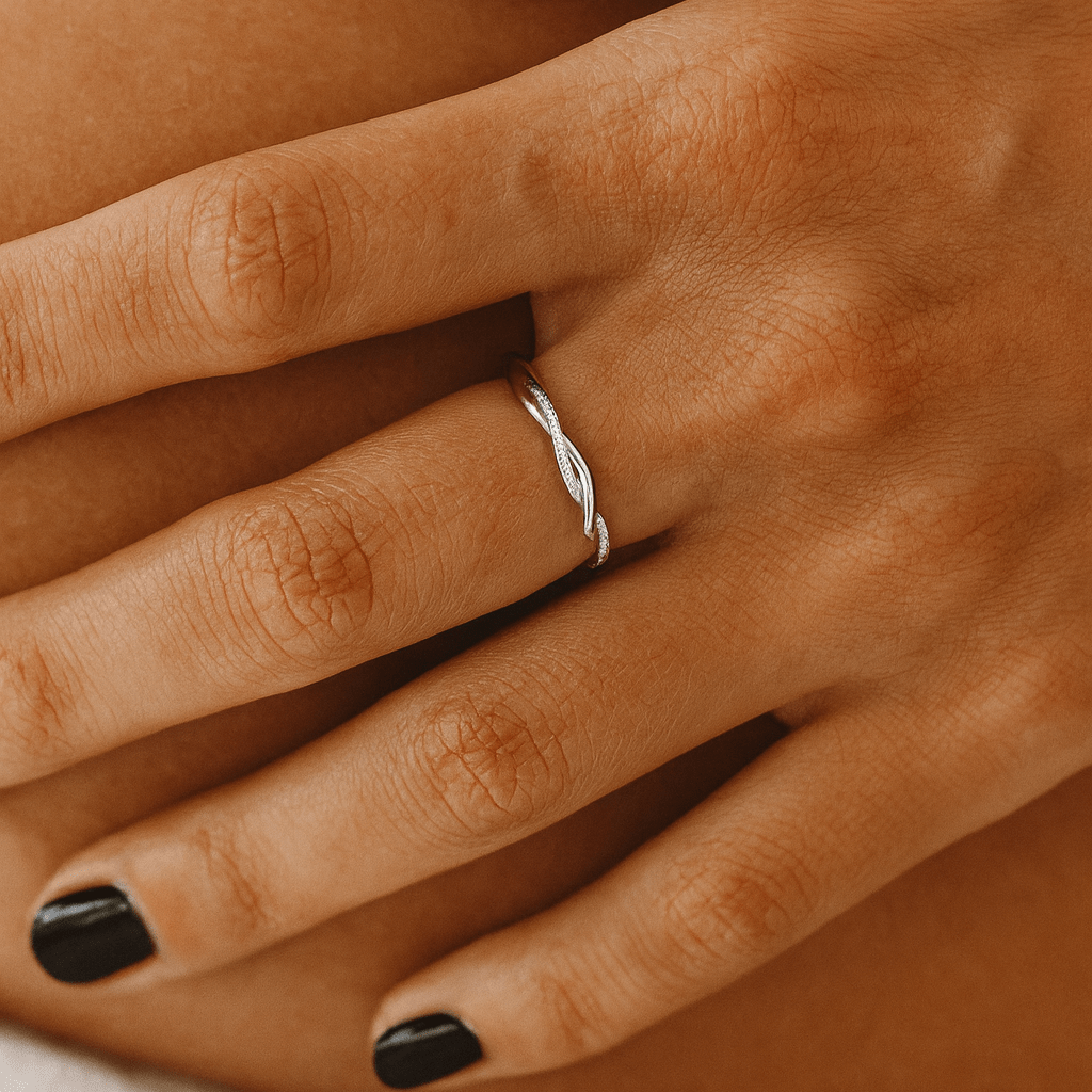 Silver Twist Ring on hand – delicate intertwined design in 925 sterling silver with moissanite accents, beach-inspired minimalist jewelry.