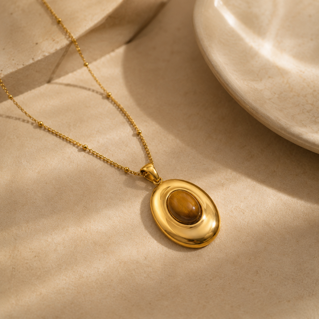 Vintage Amber Necklace with an oval amber-brown pendant on a neutral beige background.