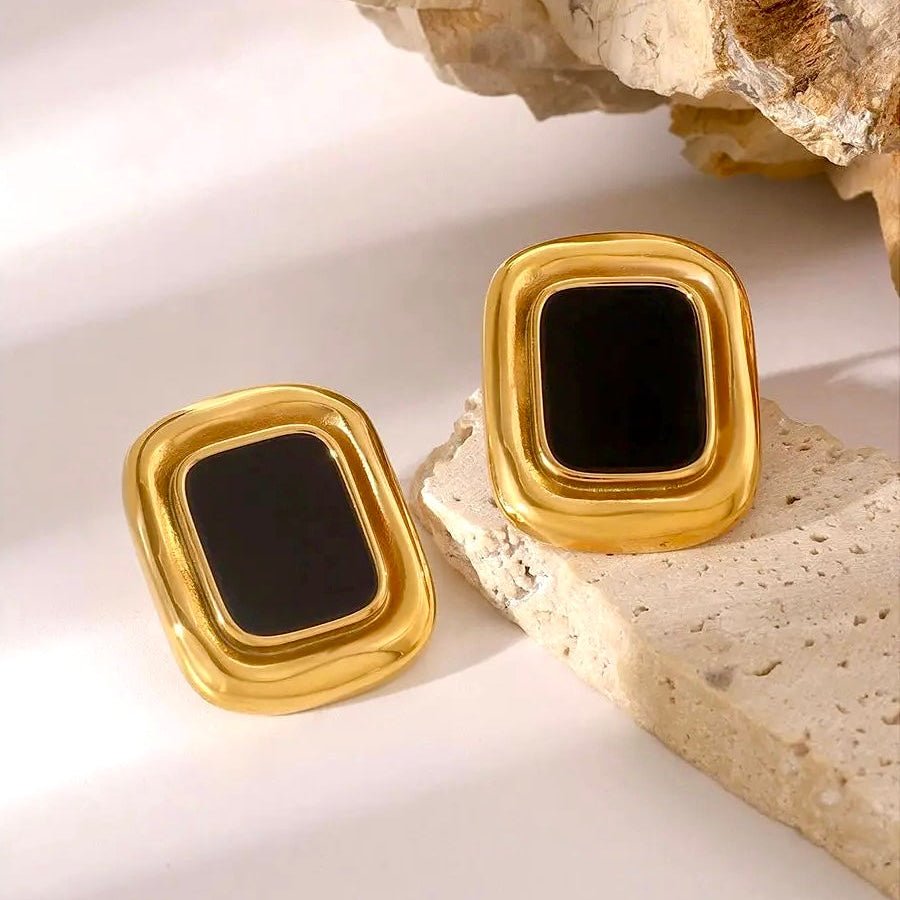 Woman wearing vintage gold and black rectangular earrings