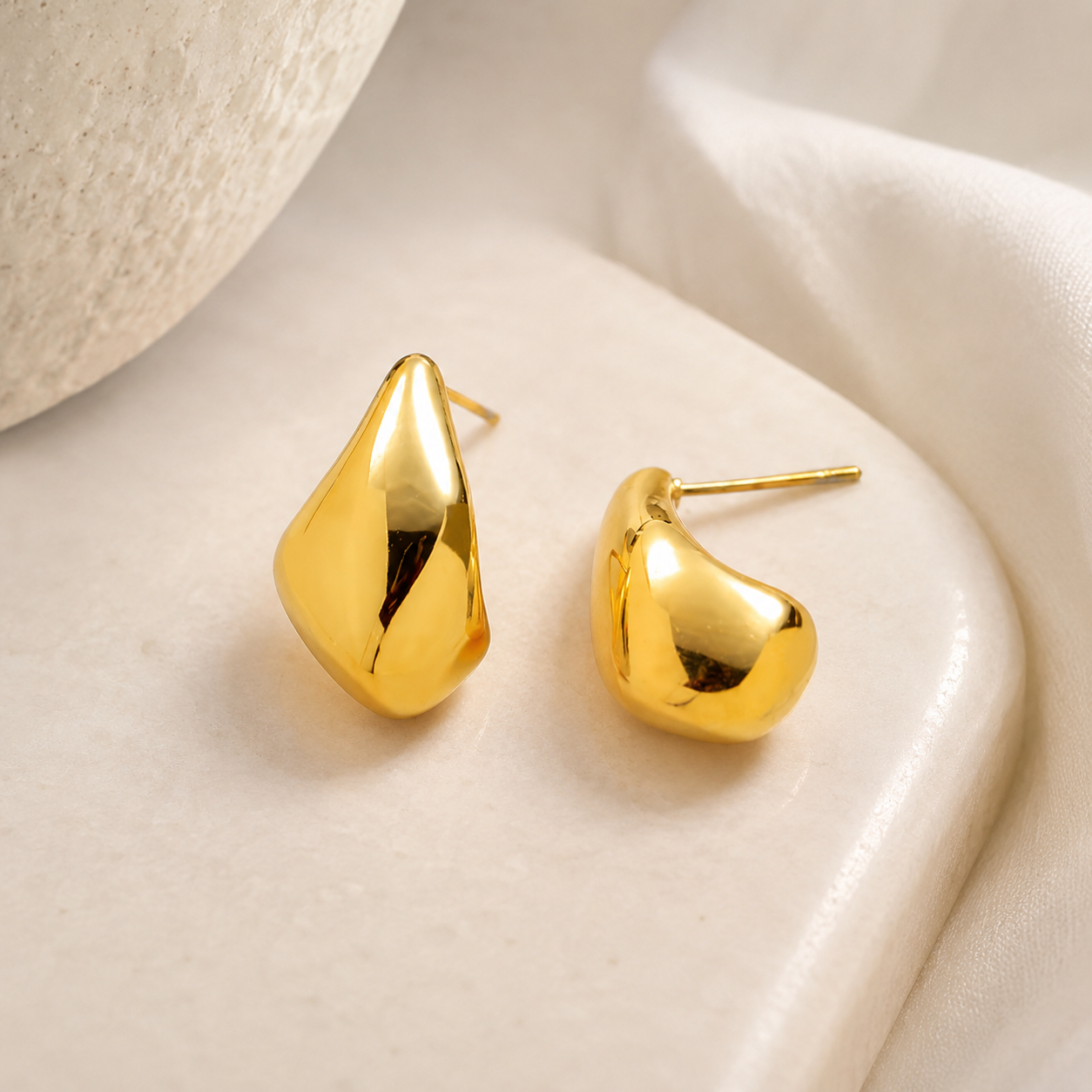 Waterproof gold teardrop stud earrings in 18K gold plated stainless steel, modern sculptural design